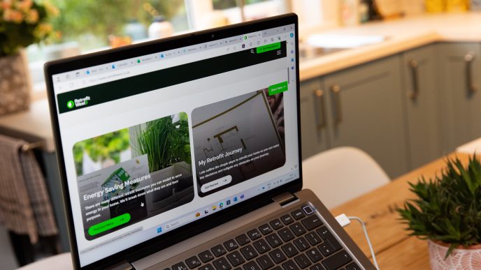 Laptop showing the Retrofit West website in Katherine's home
