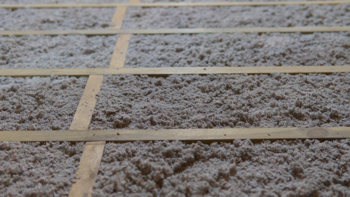 cellulose fluffy insulation fitted between timber struts
