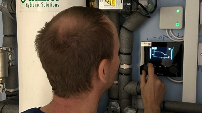 Heat Pump Engineering from Satsooma inspecting a heat pump display