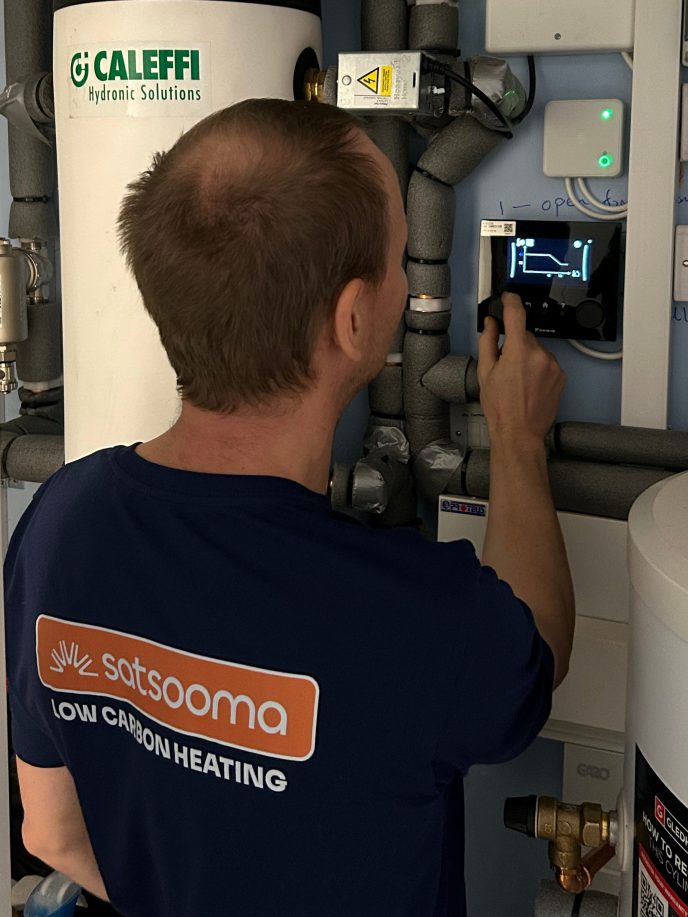 Heat Pump Engineering from Satsooma inspecting a heat pump display